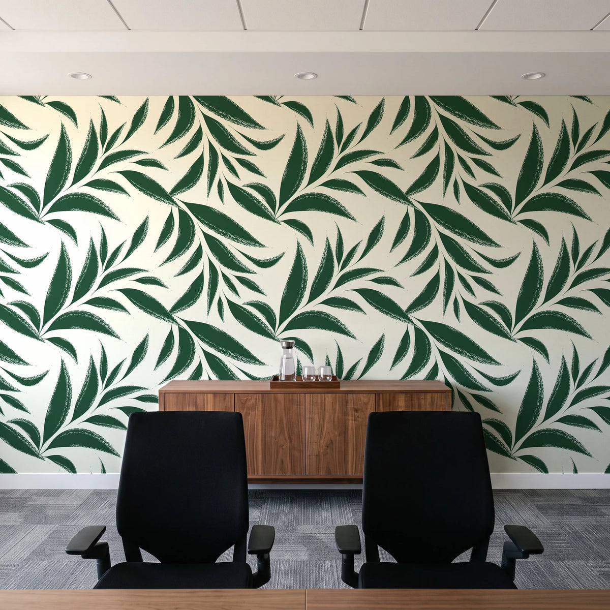 Ink Thicket Forest bold leaf wallpaper above a walnut credenza in a modern conference room