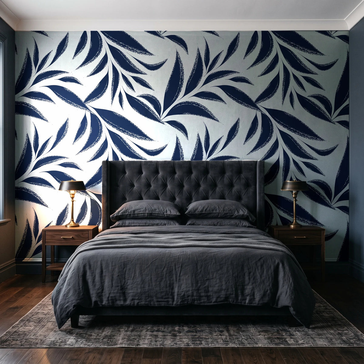Ink Thicket Midnight bold leaf wallpaper behind a tufted headboard in a dark, moody bedroom