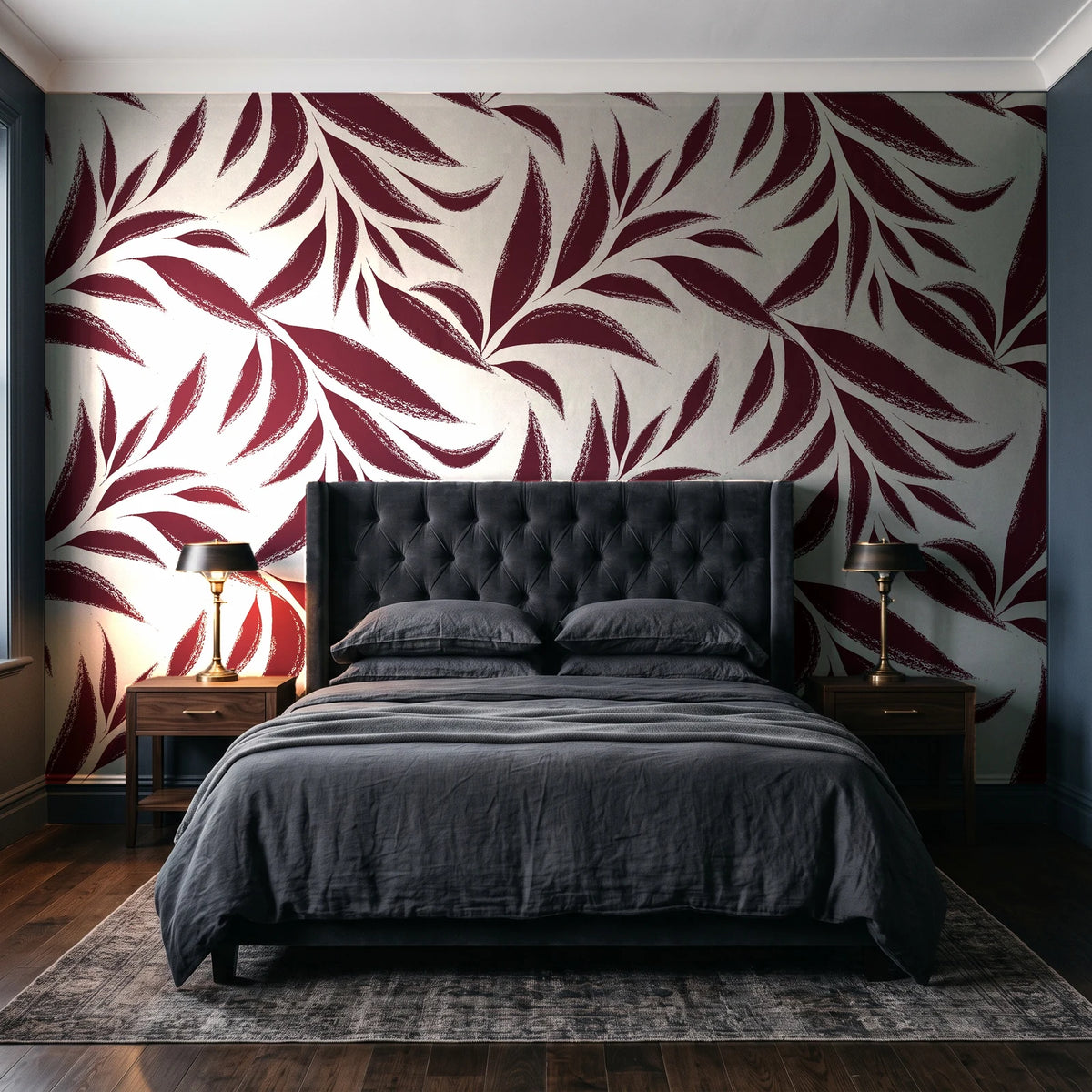 Ink Thicket Oxblood bold leaf wallpaper behind a tufted headboard in a dark, moody bedroom