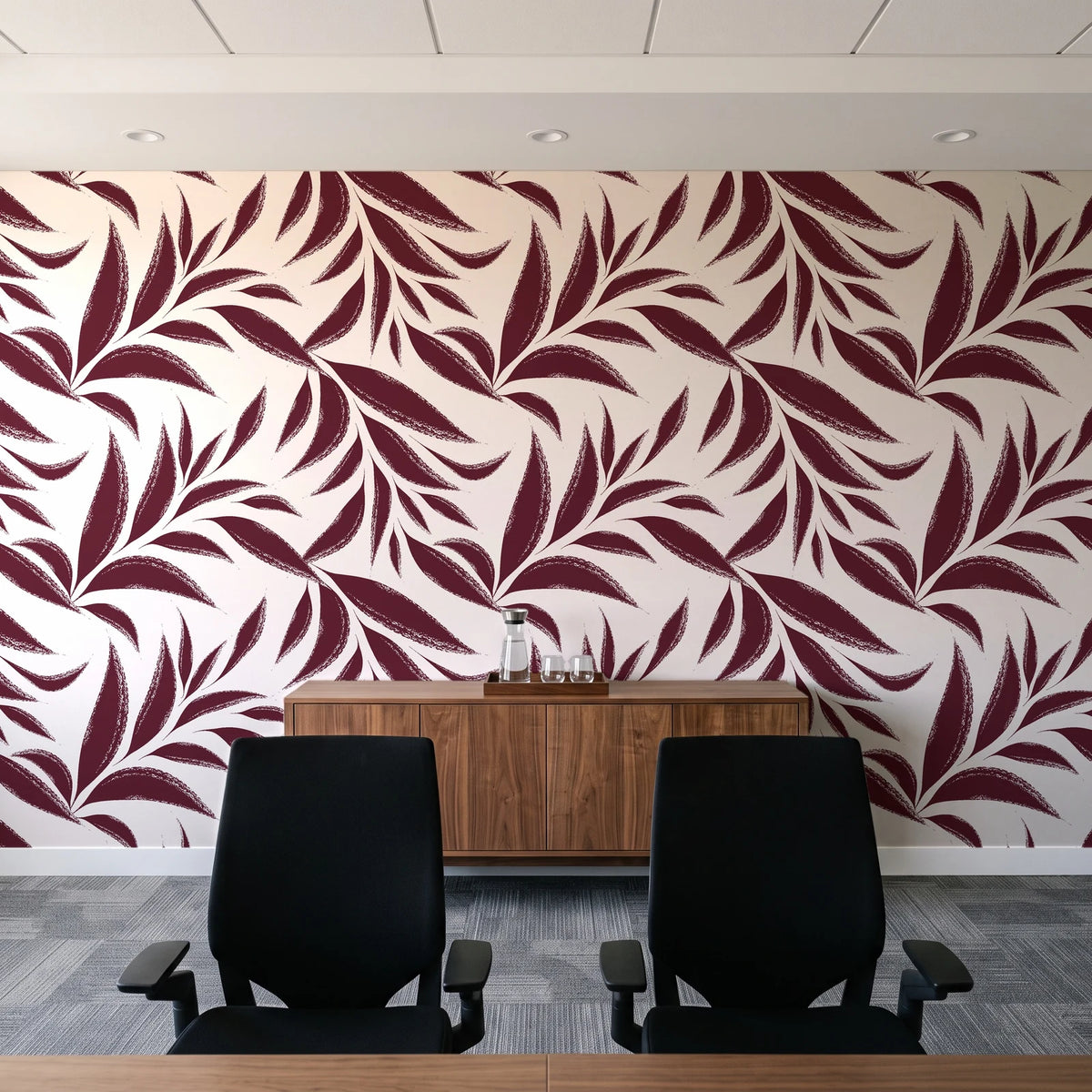 Ink Thicket Oxblood bold leaf wallpaper above a walnut credenza in a modern conference room