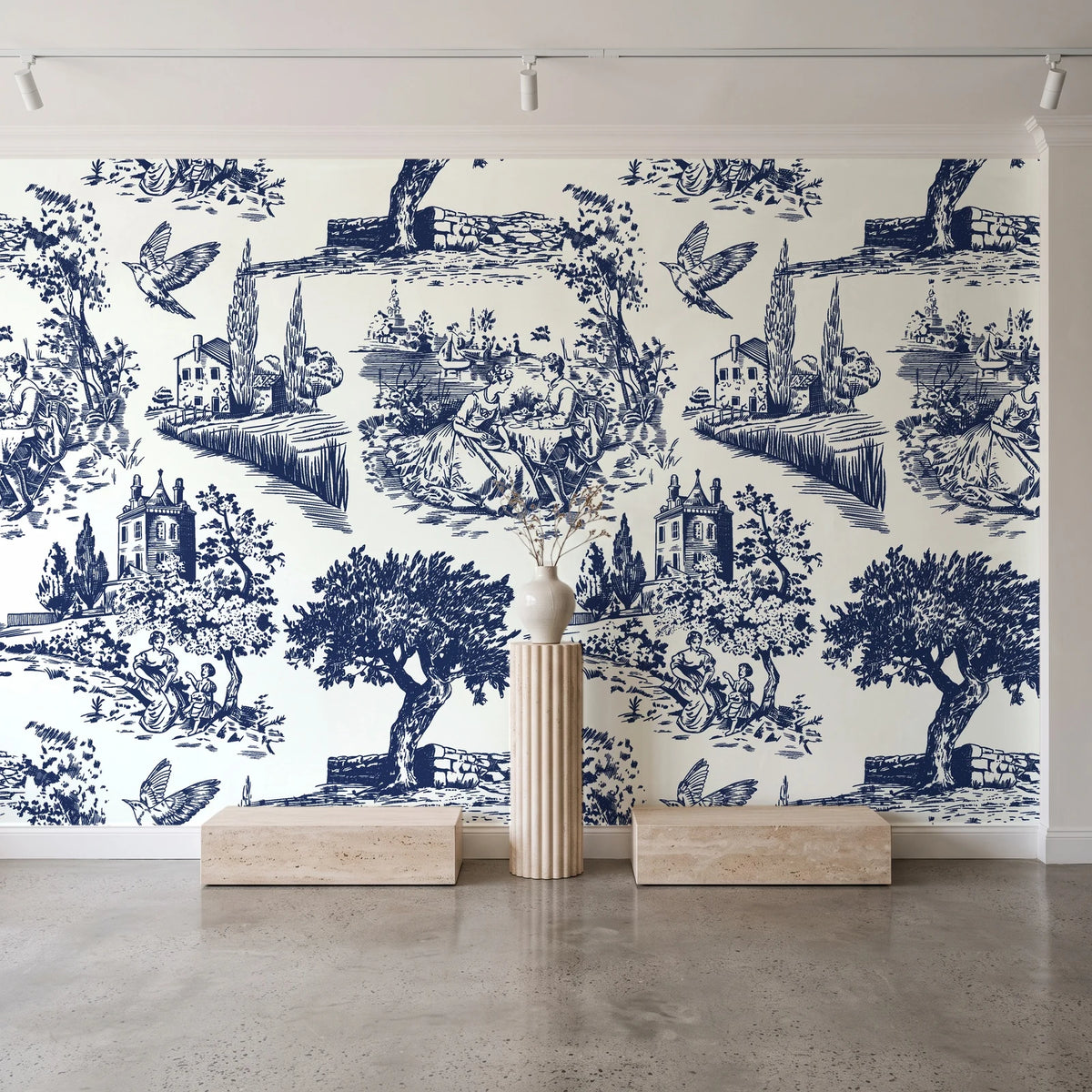 Inked Grove Midnight pastoral toile wallpaper behind a travertine pedestal and vase in a minimal boutique