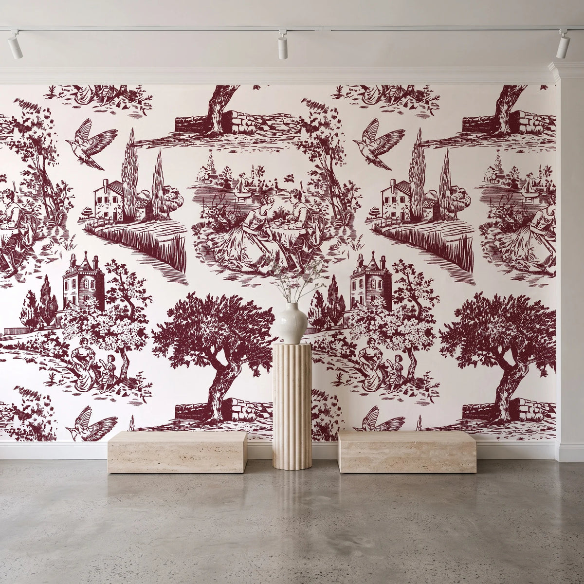 Inked Grove Oxblood pastoral toile wallpaper behind a travertine pedestal and vase in a minimal boutique