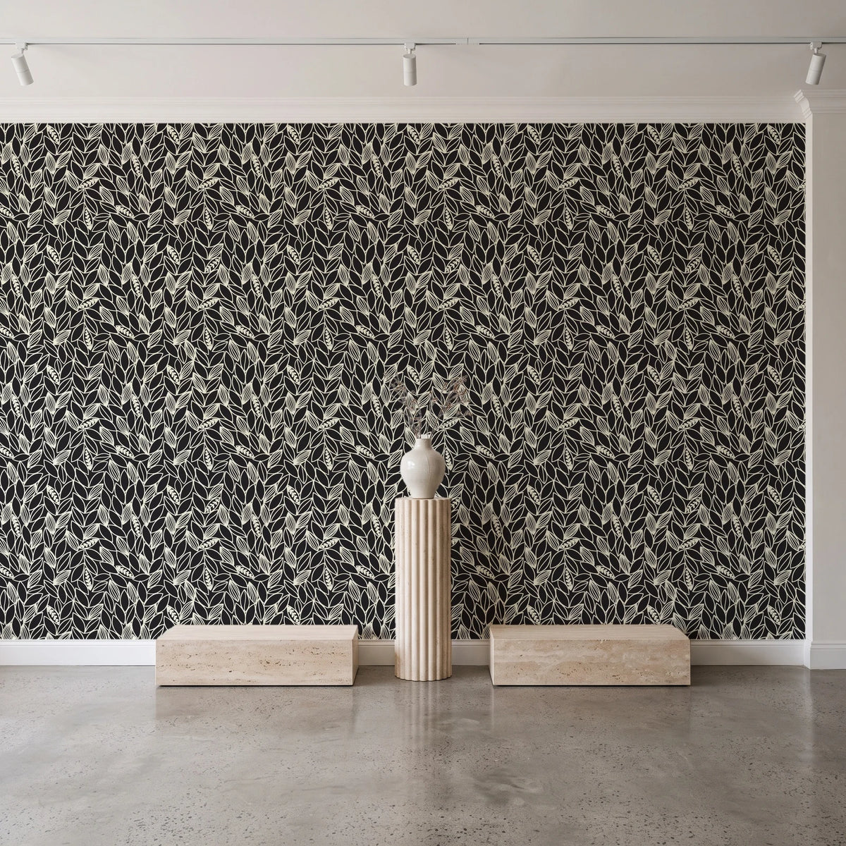 Khaki Leaf Charcoal botanical leaf wallpaper behind a travertine pedestal and vase in a minimal boutique