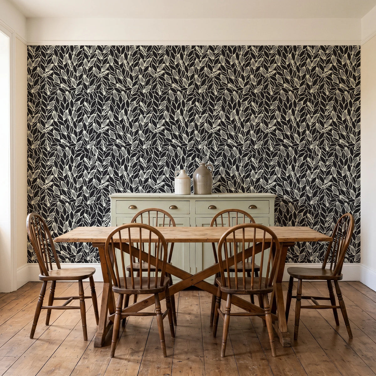 Khaki Leaf Charcoal botanical leaf wallpaper in a farmhouse dining room with a sage sideboard and rustic trestle table