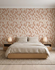 Khaki Leaf Clay botanical leaf wallpaper behind a low platform bed in a serene Japandi bedroom