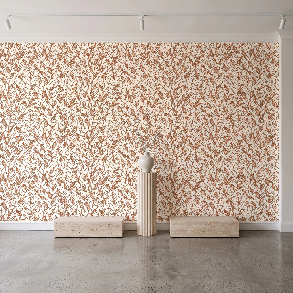 Khaki Leaf Clay botanical leaf wallpaper behind a travertine pedestal and vase in a minimal boutique