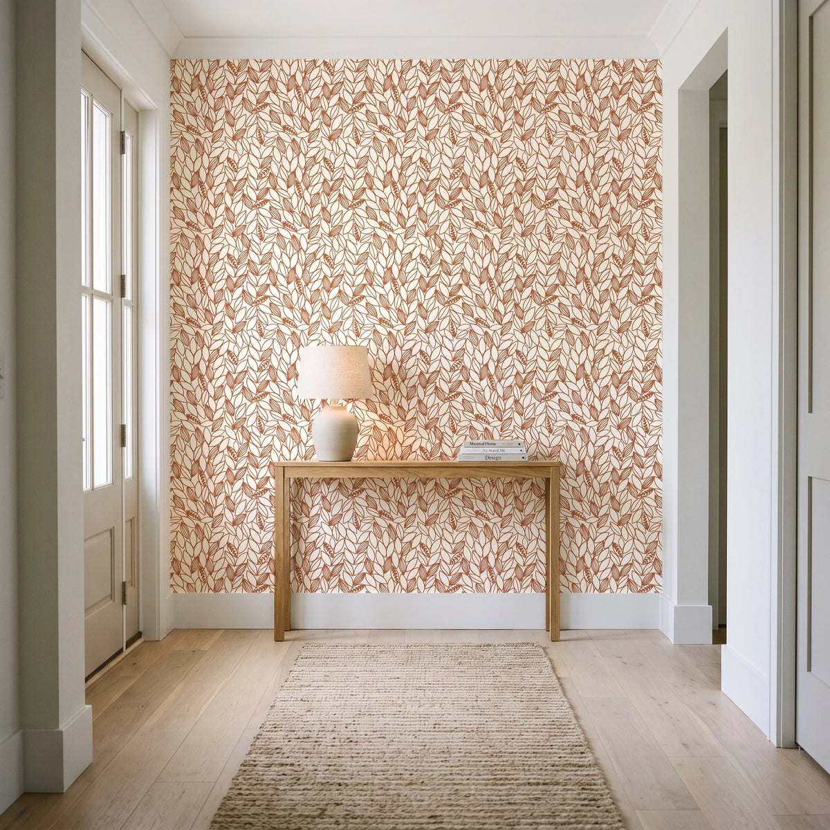 Khaki Leaf Clay botanical leaf wallpaper behind a console table in a light entry hallway