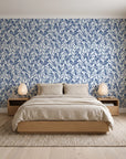 Khaki Leaf Indigo botanical leaf wallpaper behind a low platform bed in a serene Japandi bedroom
