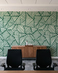 Kinetic Etch Emerald hand-drawn lines wallpaper above a walnut credenza in a modern conference room