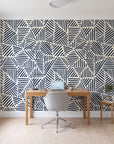 Kinetic Etch Ink hand-drawn lines wallpaper behind a modern oak desk in a bright home office