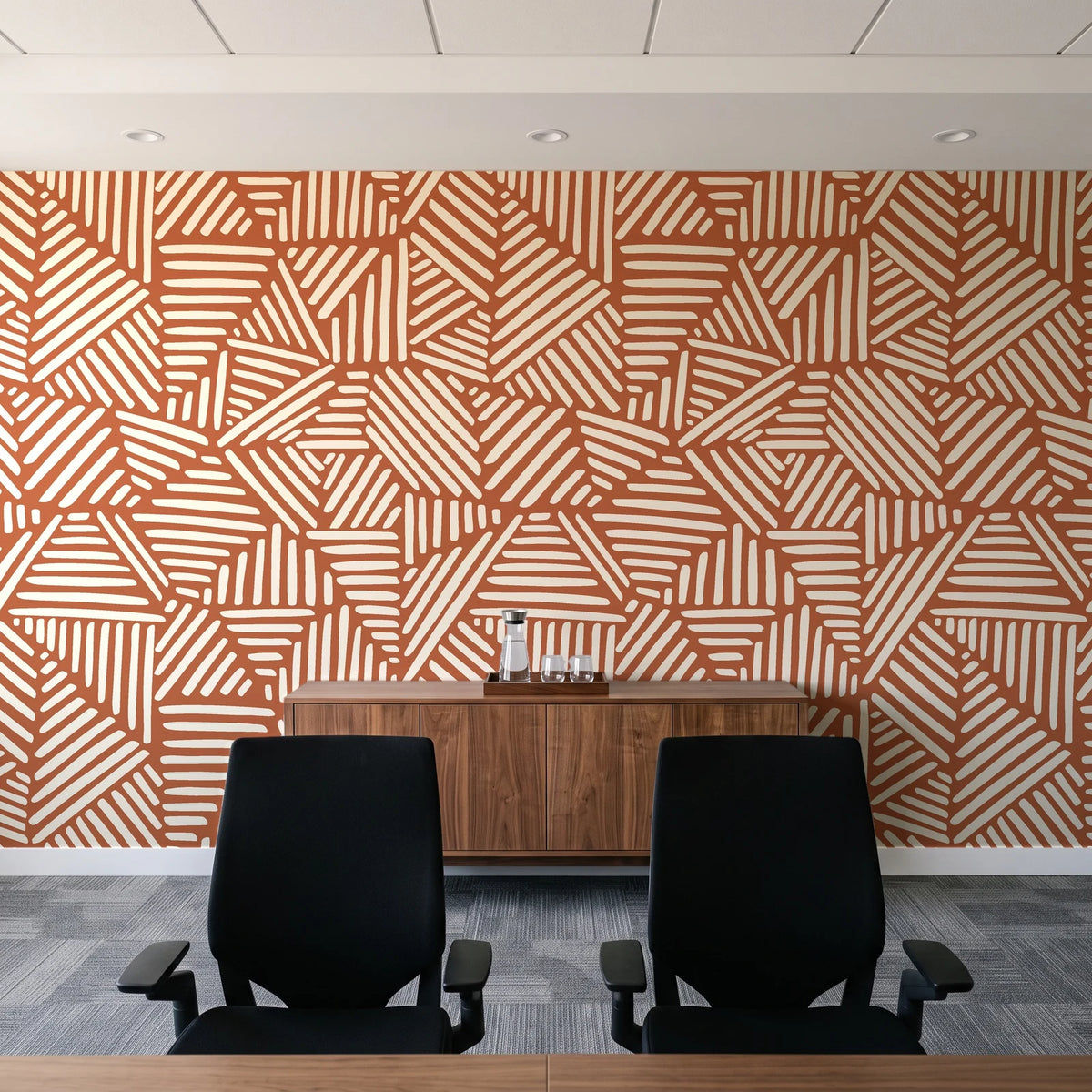 Kinetic Etch Terracotta hand-drawn lines wallpaper above a walnut credenza in a modern conference room