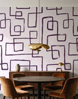 Linear Circuit Plum minimalist line wallpaper behind a walnut credenza and round table in an elegant dining room