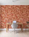 Linear Circuit Terracotta minimalist line wallpaper behind a modern oak desk in a bright home office