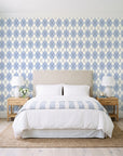 Linen Diamonds Navy argyle wallpaper behind a queen bed in a bright coastal bedroom