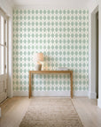 Linen Diamonds Sage argyle wallpaper behind a console table in a light entry hallway