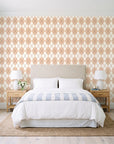 Linen Diamonds Terracotta argyle wallpaper behind a queen bed in a bright coastal bedroom