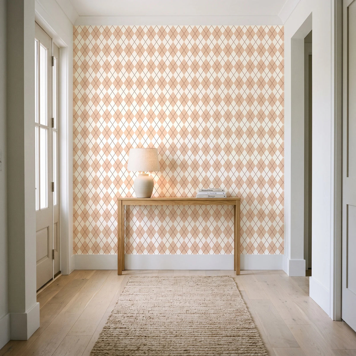 Linen Diamonds Terracotta argyle wallpaper behind a console table in a light entry hallway