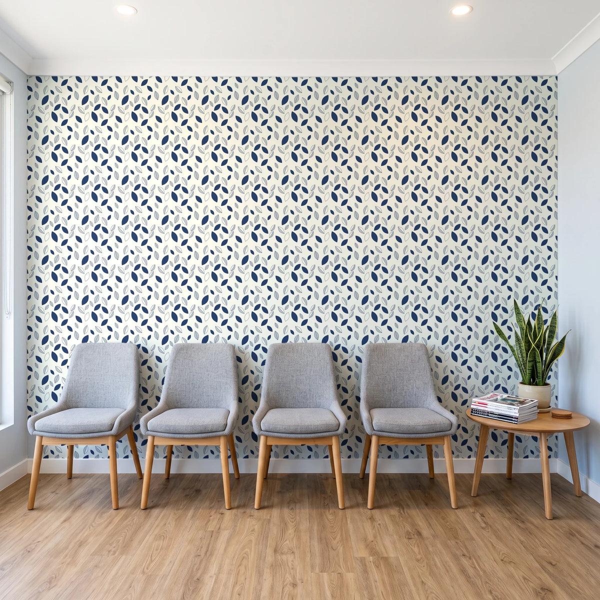 Linen & Leaf Indigo leaf wallpaper behind a row of upholstered chairs in a bright clinic waiting room