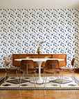 Linen & Leaf Indigo leaf wallpaper in a mid-century dining room with a teak sideboard and tulip table