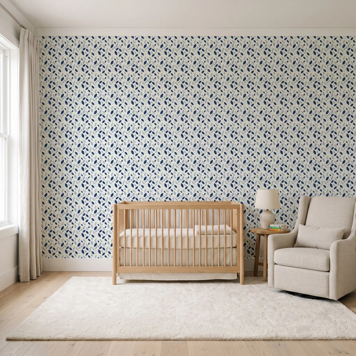 Linen & Leaf Indigo leaf wallpaper in a calm, light-filled nursery