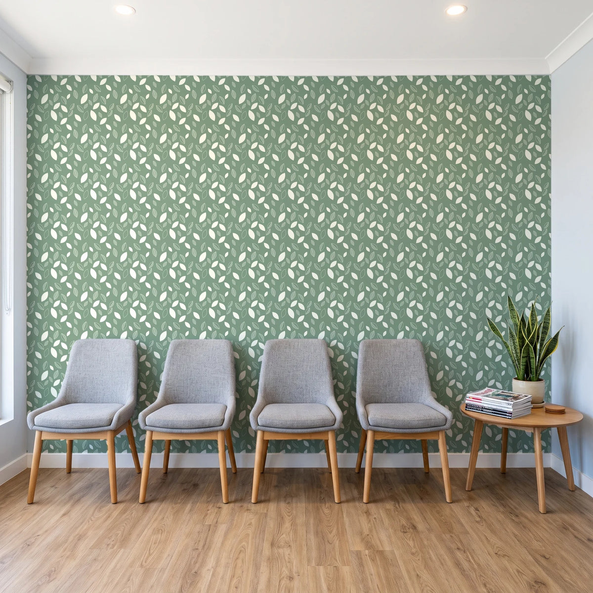 Linen & Leaf Sage leaf wallpaper behind a row of upholstered chairs in a bright clinic waiting room