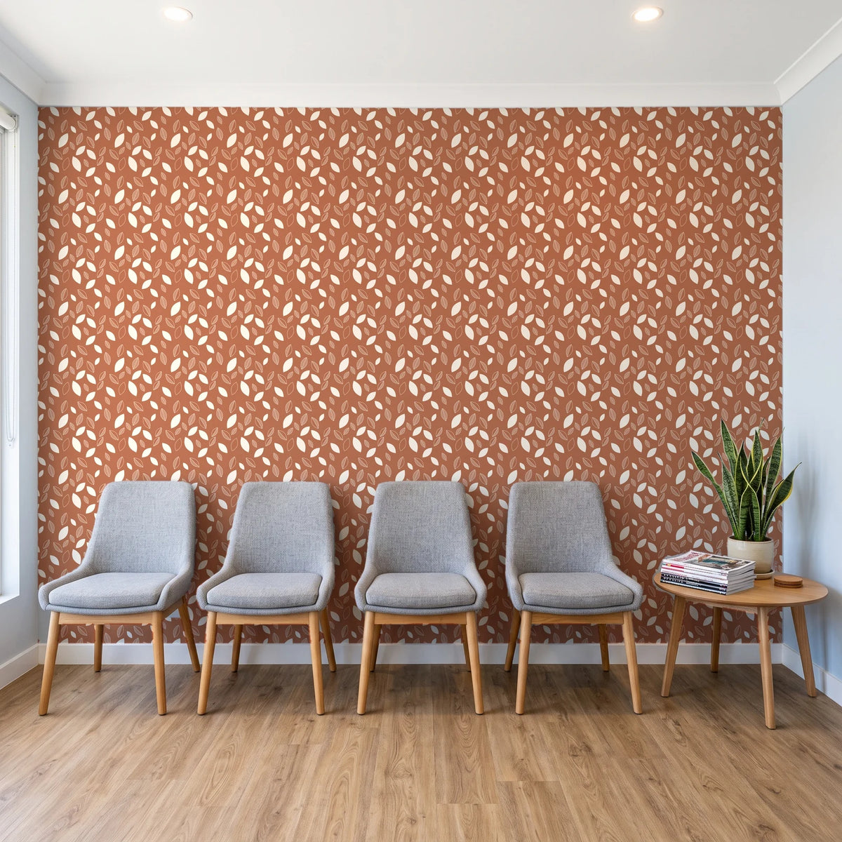 Linen & Leaf Terracotta leaf wallpaper behind a row of upholstered chairs in a bright clinic waiting room