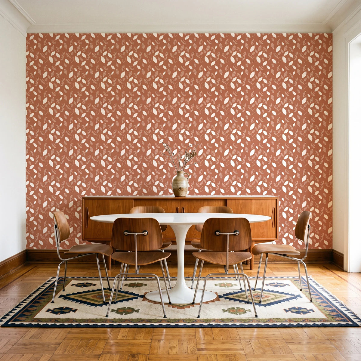 Linen & Leaf Terracotta leaf wallpaper in a mid-century dining room with a teak sideboard and tulip table