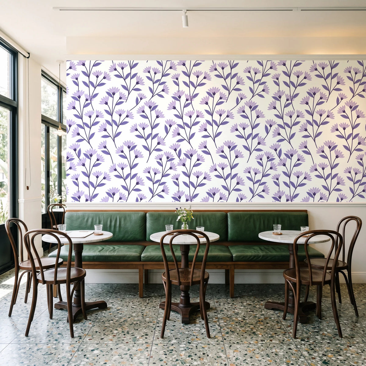 Meadow Light Lavender meadow flower wallpaper above a green leather banquette in a sunlit neighborhood cafe