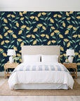 Meadow Light Midnight meadow flower wallpaper behind a queen bed in a bright coastal bedroom
