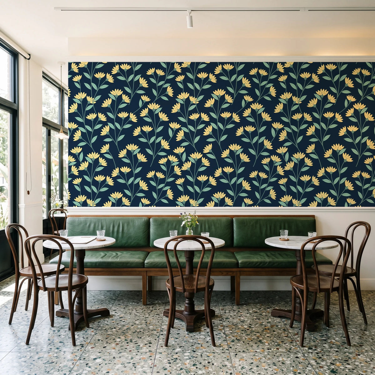 Meadow Light Midnight meadow flower wallpaper above a green leather banquette in a sunlit neighborhood cafe