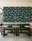 Meadow Light Midnight meadow flower wallpaper above a green leather banquette in a sunlit neighborhood cafe