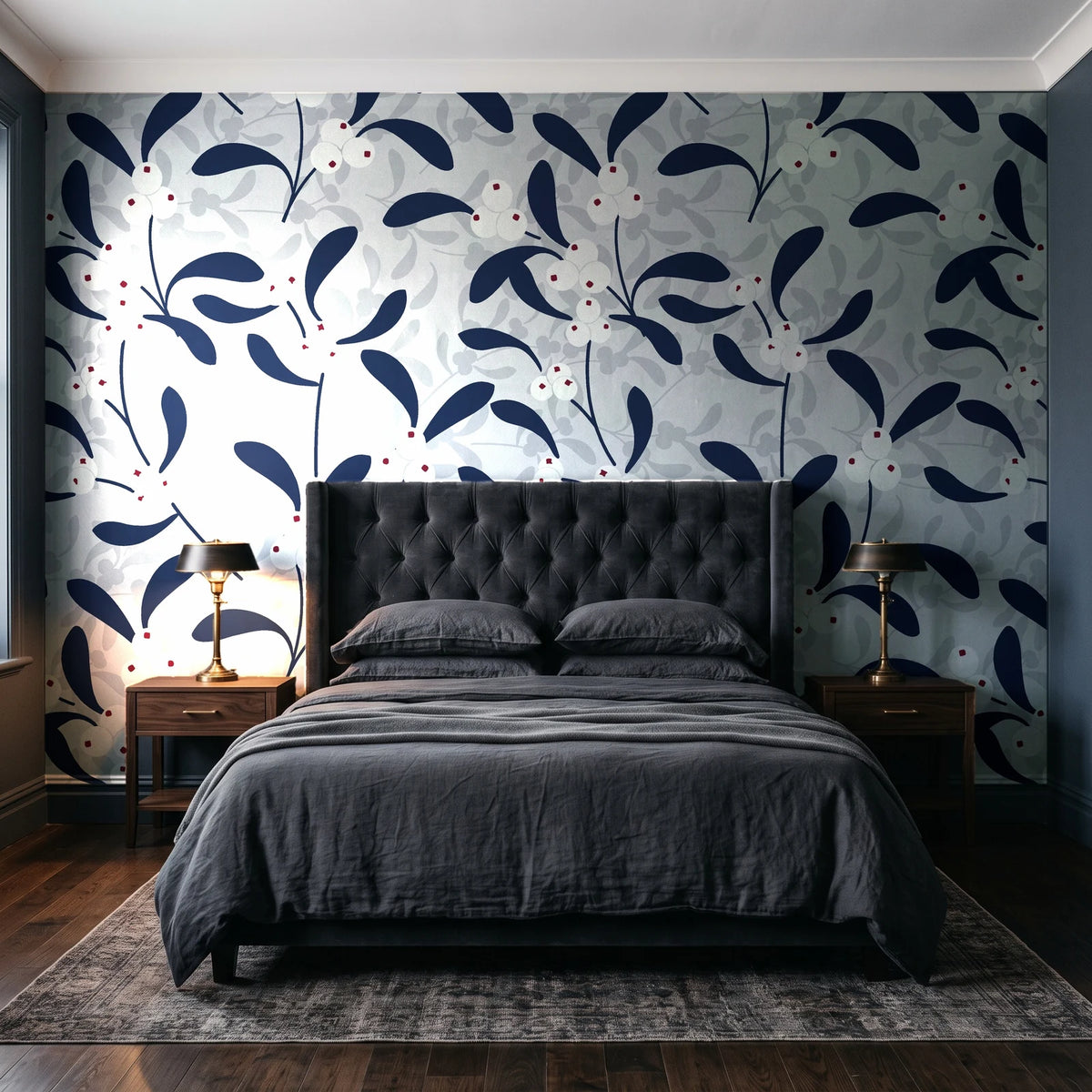 Mistletoe Trail Navy mistletoe wallpaper behind a tufted headboard in a dark, moody bedroom