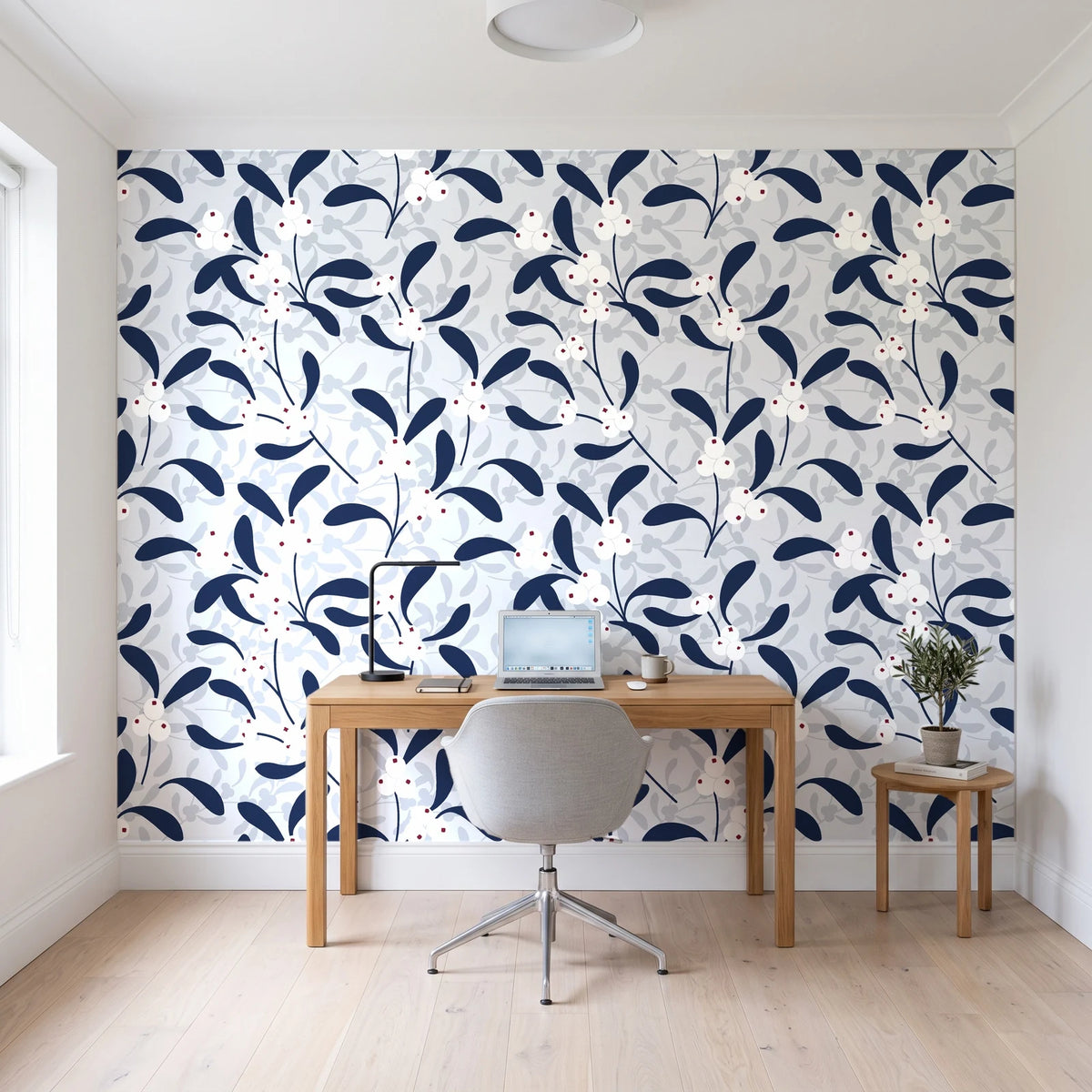 Mistletoe Trail Navy mistletoe wallpaper behind a modern oak desk in a bright home office
