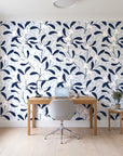 Mistletoe Trail Navy mistletoe wallpaper behind a modern oak desk in a bright home office