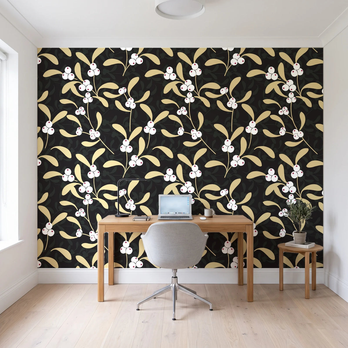 Mistletoe Trail Noir mistletoe wallpaper behind a modern oak desk in a bright home office