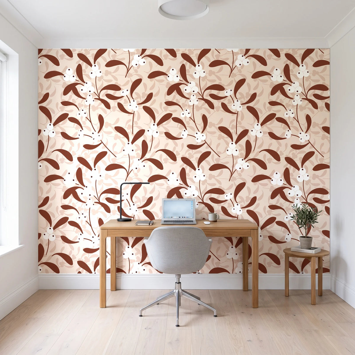 Mistletoe Trail Terracotta mistletoe wallpaper behind a modern oak desk in a bright home office