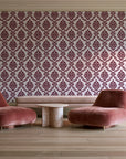 Misty Fern Romance Oxblood damask wallpaper in a boutique hotel sitting area