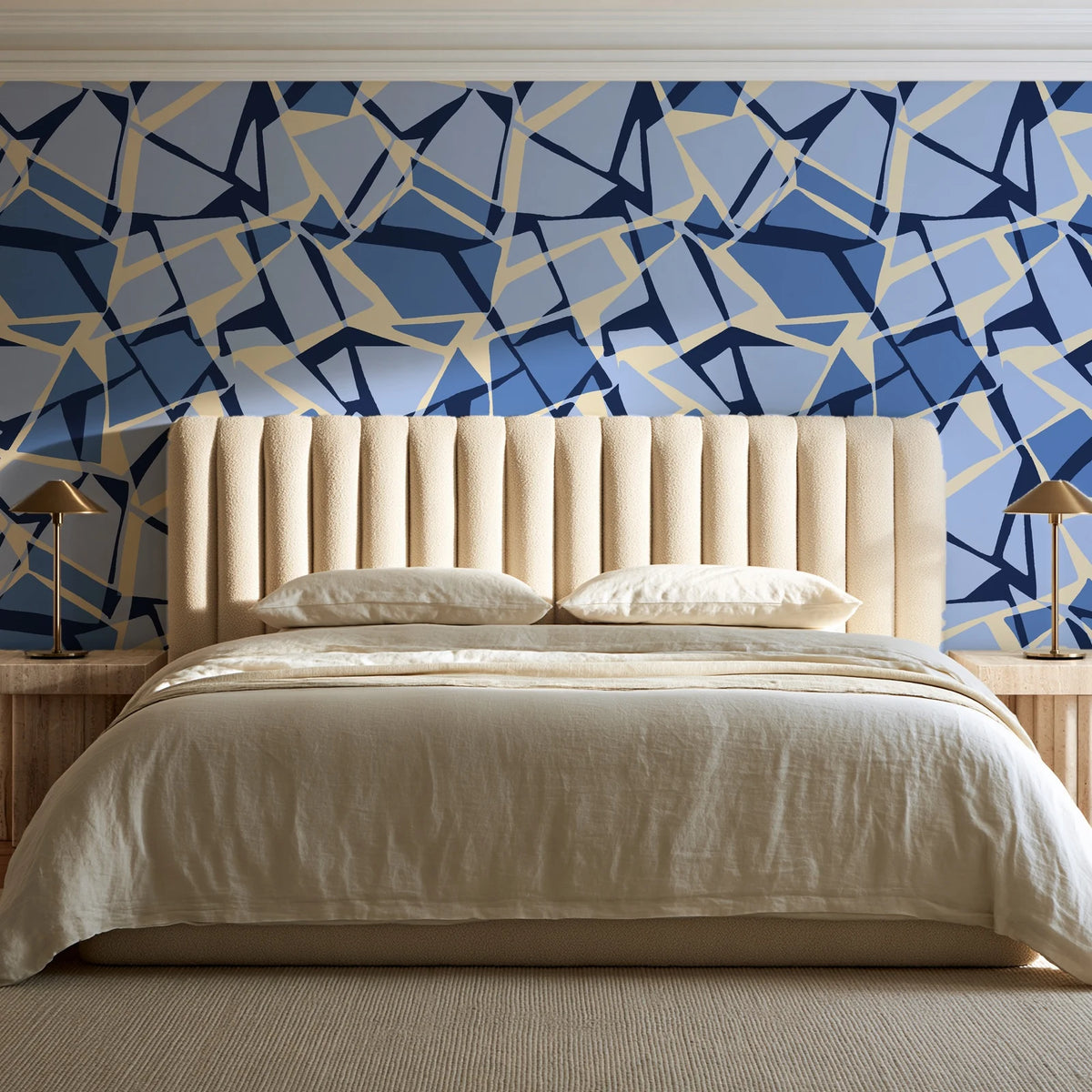 Muted Block Indigo geometric wallpaper behind a channel-tufted bed in a calm primary bedroom