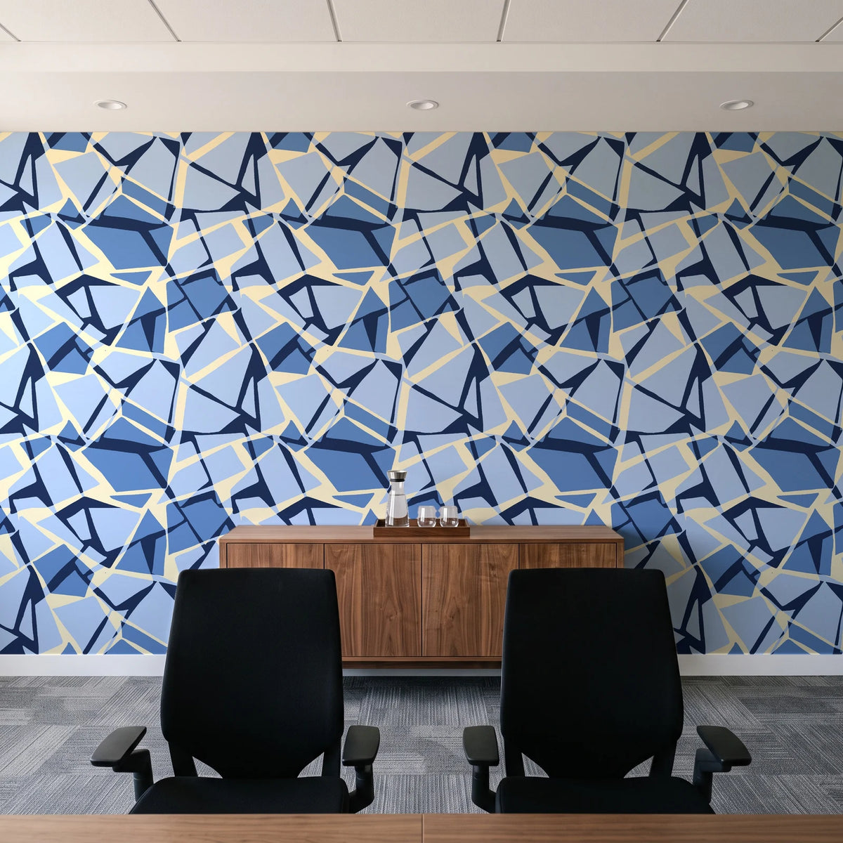 Muted Block Indigo geometric wallpaper above a walnut credenza in a modern conference room