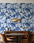 Muted Block Indigo geometric wallpaper behind a walnut credenza and round table in an elegant dining room