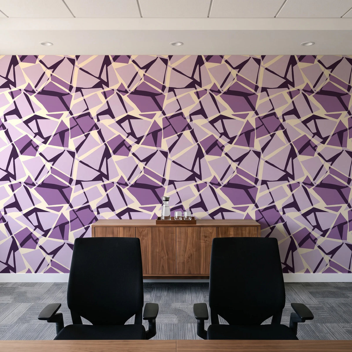 Muted Block Plum geometric wallpaper above a walnut credenza in a modern conference room