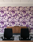 Muted Block Plum geometric wallpaper above a walnut credenza in a modern conference room