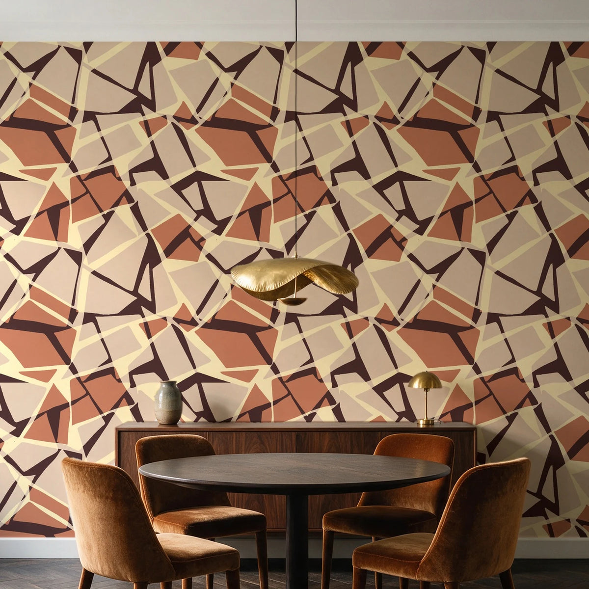 Muted Block Terracotta geometric wallpaper behind a walnut credenza and round table in an elegant dining room