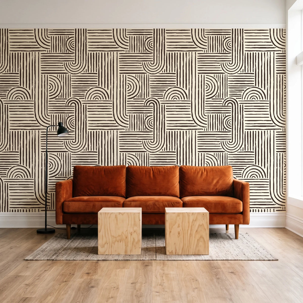 Nomad Stripe Espresso geometric wallpaper behind a rust velvet sofa in a bright coworking lounge