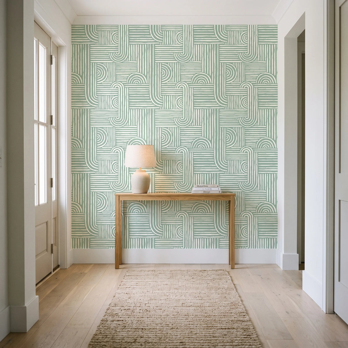 Nomad Stripe Sage geometric wallpaper behind a console table in a light entry hallway