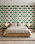 Ocean Fortress Ivory art deco scale wallpaper behind a low platform bed in a serene Japandi bedroom