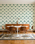 Ocean Fortress Ivory art deco scale wallpaper in a mid-century dining room with a teak sideboard and tulip table