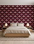 Ocean Fortress Oxblood art deco scale wallpaper behind a low platform bed in a serene Japandi bedroom