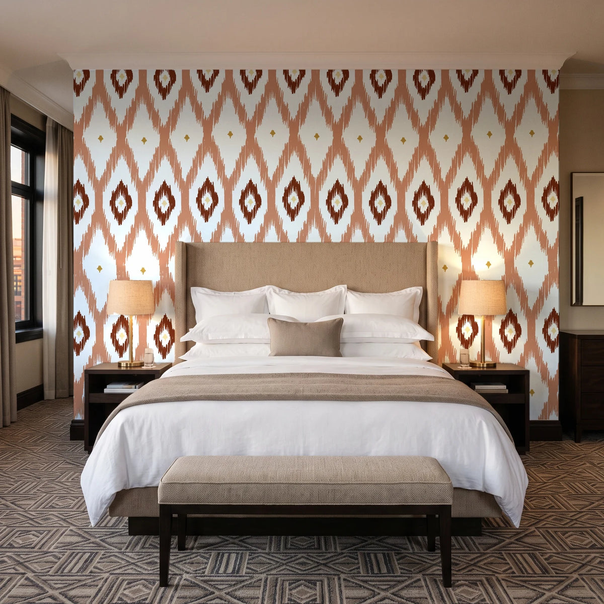 Ogee Loom Terracotta ikat ogee wallpaper behind the headboard of a king bed in a contemporary hotel guest room