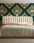 Old World Flora Evergreen floral damask wallpaper behind a channel-tufted bed in a calm primary bedroom